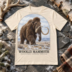 Woolly Mammoth t-shirt flat lay – natural PaleoThreads paleo art tee on frosty slate with an antler