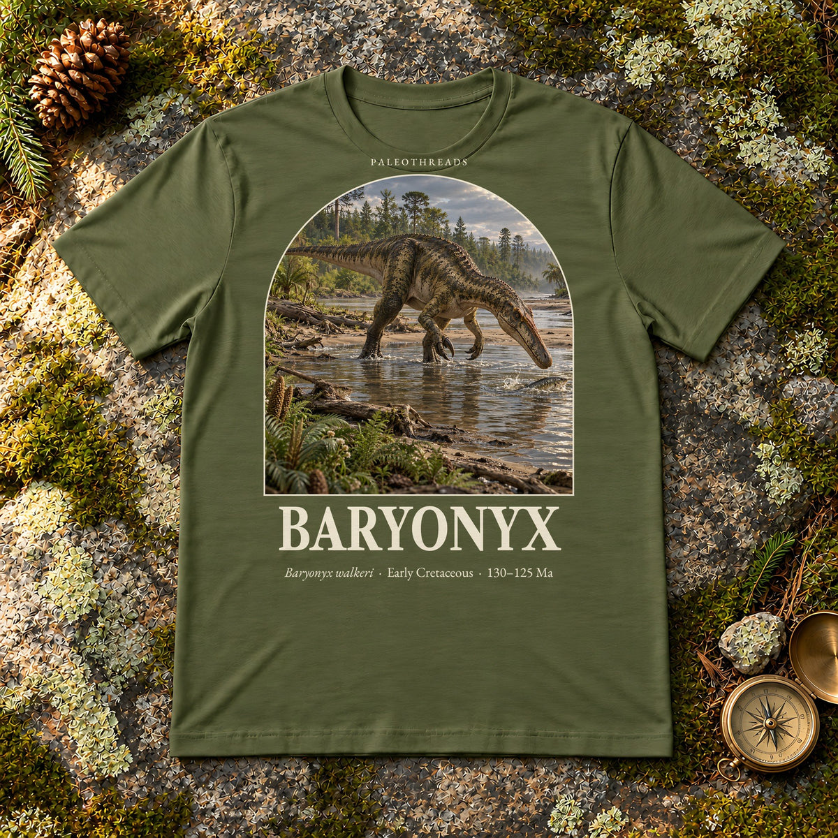 Baryonyx t-shirt flat lay – military green PaleoThreads paleo art tee on mossy rock with a brass compass