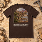 Herrerasaurus t-shirt flat lay – brown PaleoThreads paleo art tee on sandstone with a rock hammer