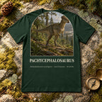 Pachycephalosaurus t-shirt flat lay – forest PaleoThreads paleo art tee on mossy rock with a brass compass