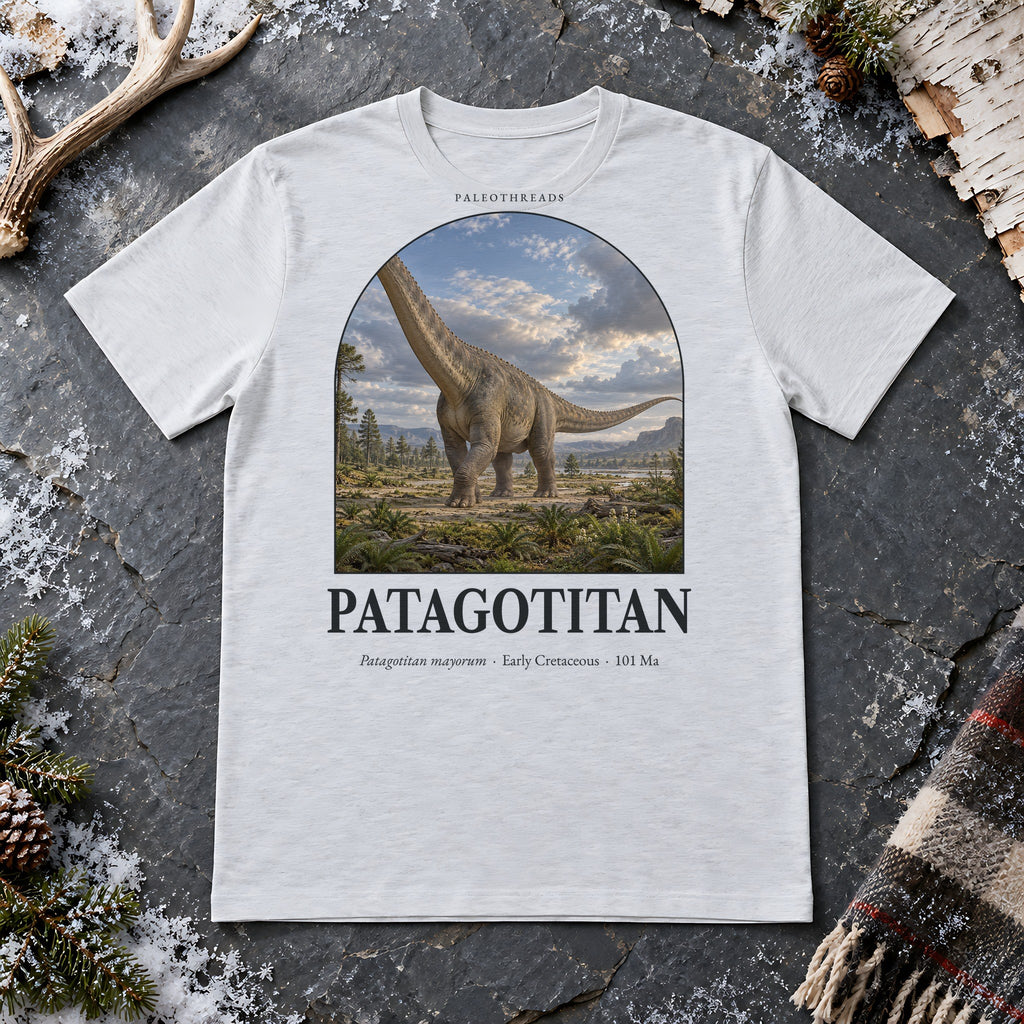 Patagotitan t-shirt flat lay – ash PaleoThreads paleo art tee on frosty slate with an antler