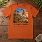 Tupandactylus t-shirt flat lay – autumn PaleoThreads paleo art tee on a walnut field desk with ferns