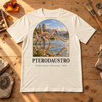 Pterodaustro t-shirt flat lay – soft cream PaleoThreads paleo art tee on a fossil prep bench with amber