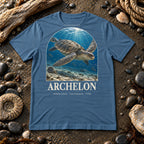 Archelon t-shirt flat lay – steel blue PaleoThreads paleo art tee on a fossil beach with driftwood