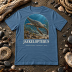 Jaekelopterus t-shirt flat lay – steel blue PaleoThreads paleo art tee on a fossil beach with driftwood