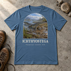 Ichthyostega t-shirt flat lay – steel blue PaleoThreads paleo art tee with hiking boots and an ammonite