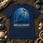 Megalodon t-shirt flat lay – navy PaleoThreads paleo art tee on a fossil beach with driftwood