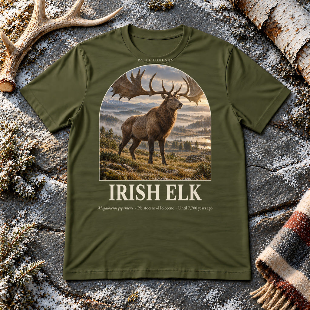 Irish Elk t-shirt flat lay – olive PaleoThreads paleo art tee on frosty slate with an antler