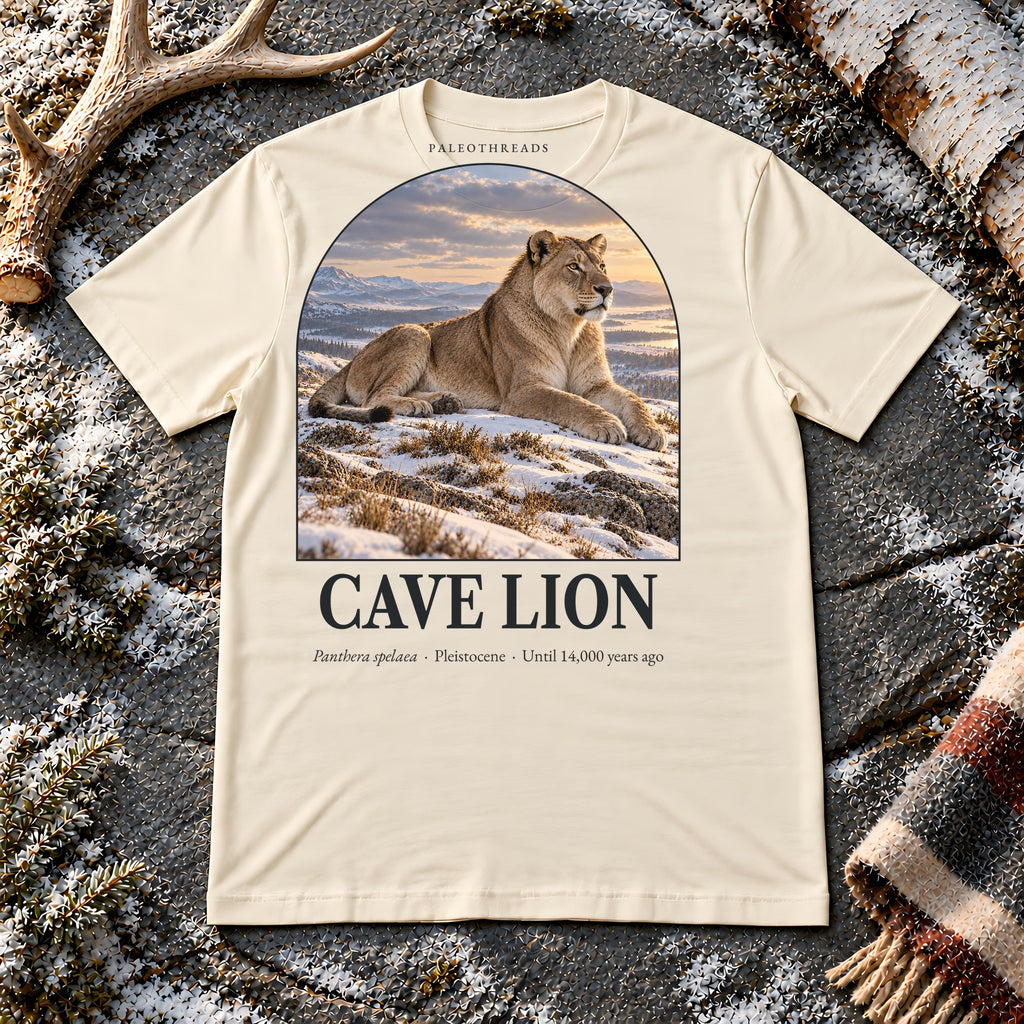 Cave Lion t-shirt flat lay – soft cream PaleoThreads paleo art tee on frosty slate with an antler